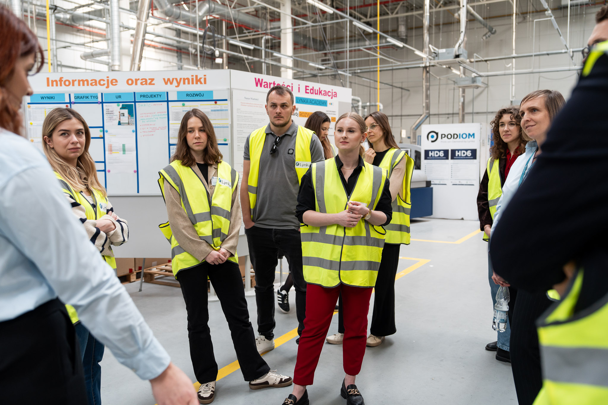 Uczestnicy przyglądający się pracy maszyn w hali PromoExpress.